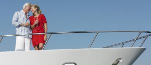 couple hugging on bow of yacht